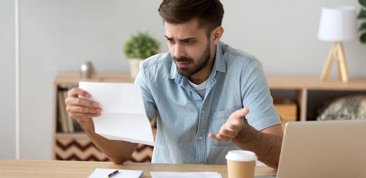 Frustrated man reviewing his taxes.